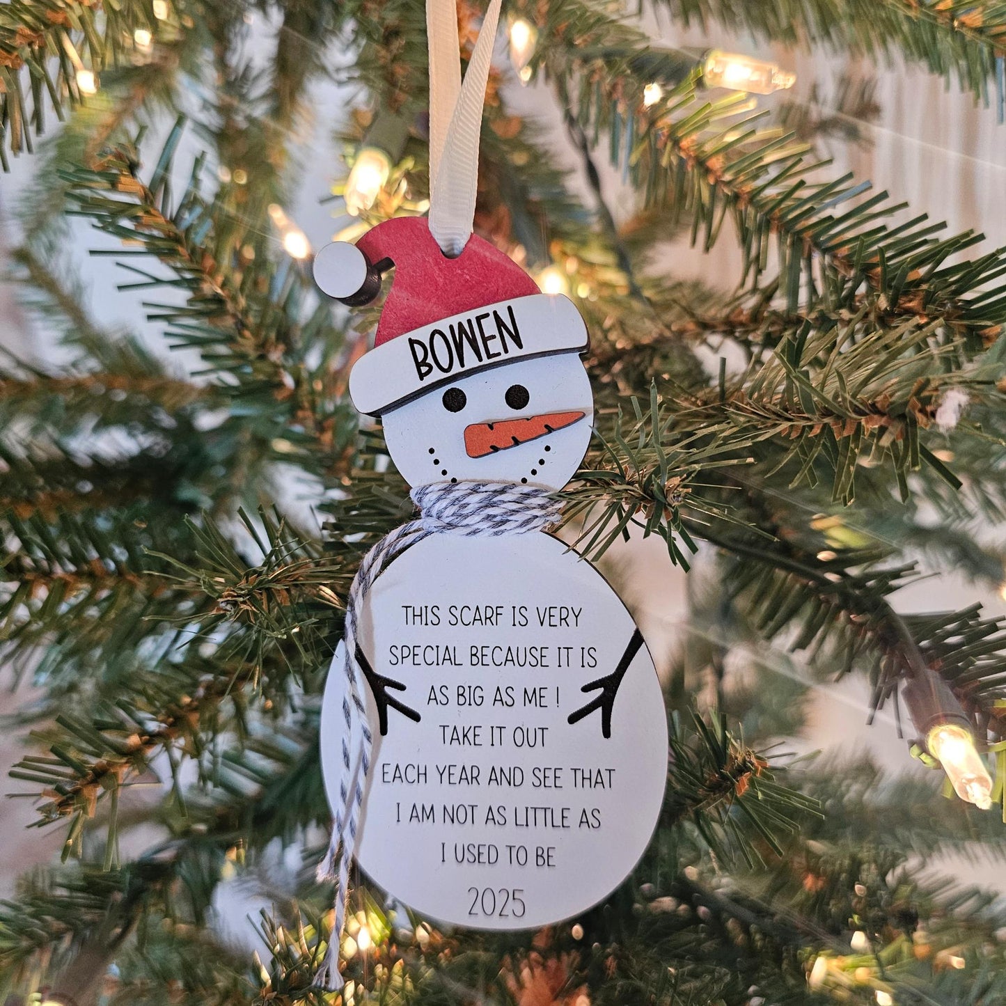 Wooden snowman ornament with a 4-foot yarn scarf for measuring a child’s height