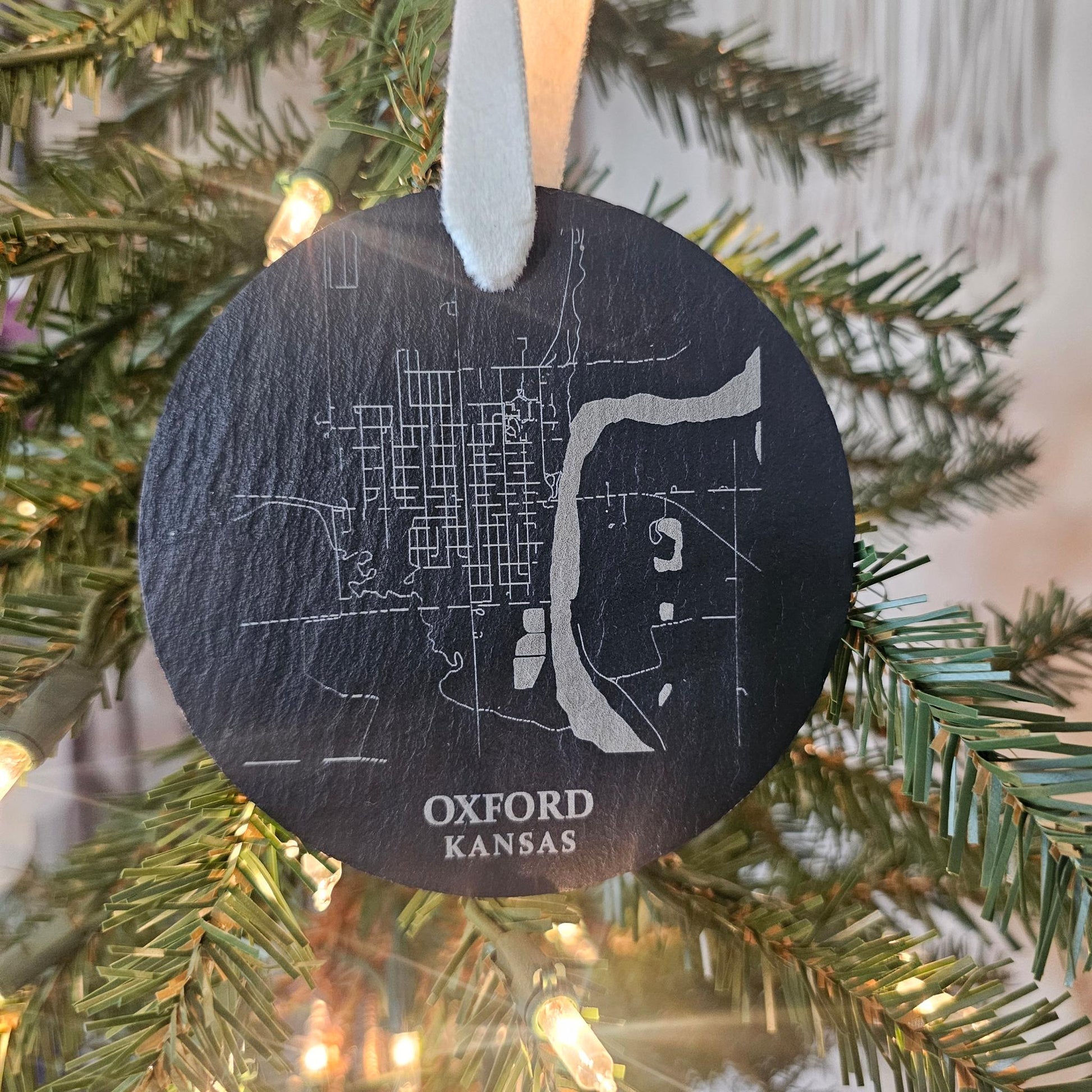 Engraved slate ornament with the city map of Oxford, Kansas and kraft packaging